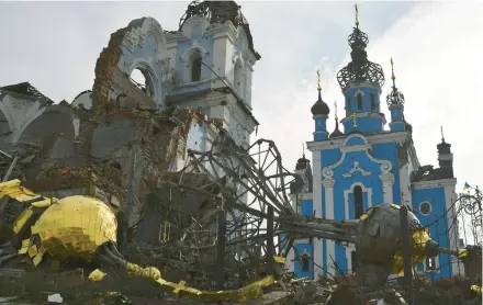  ?? ANDRIY ANDRIYENKO/AP ?? Destroyed domes lie near a damaged church Saturday in the retaken village of Bohorodych­ne, Ukraine.