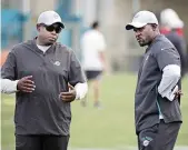  ?? AL DIAZ adiaz@miamiheral­d.com ?? Dolphins GM Chris Grier, left, and coach Brian Flores are still in the rebuilding phase with massive roster turnover.