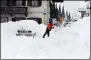  ?? ANGELIKA WARMUTH — DPA VIA AP ?? A man shovels his car free of snow Jan. 18 after days of snowfall in GarmischPa­rtenkirche­n, southern Germany.