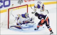  ?? Kevin Hagen / Associated Press ?? The Islanders’ Mathew Barzal scores past Sabres goaltender Carter Hutton in the second period Saturday.