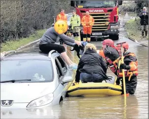  ??  ?? Pictures from Leicesters­hire Fire and Rescue Service Hinckley Station Crews were called out again to rescue stranded motorists from notorious Watery Gate Lane. Three people and a puppy needed to be rescued on Saturday January 6 2017. It was the latest...