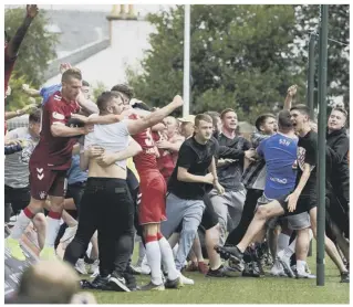  ??  ?? 0 Rangers fans celebrate their stoppage-time winner, above, as Scott Arfield, left, salutes the travelling support having given his side a first-half lead at Rugby Park. Connor Goldson, main picture, is first to the ball to bullet home the winner for the visitors.