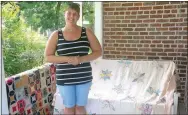  ?? Photo by Susan Holland ?? Erin McVittie posed on the front porch of the Gravette Historical Museum with some of the museum’s vintage quilts. McVittie has announced the museum will be open all day on Gravette Day, Saturday, Aug. 13.