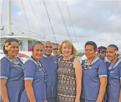  ??  ?? Fifth from left: Jackie Charltion with the staff of Captain Cook Cruises at Port Denarau, Nadi.