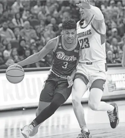  ?? ?? Drake’s Colby Garland drives to the basket as Washington State’s Andrej Jakimovski defends during their NCAA Tournament game Thursday.