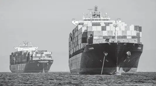  ?? Tribune News Service ?? Two of dozens of ships sit off the coast of the Ports of Los Angeles and Long Beach, waiting to be unloaded. Despite the supply chain mess, shippers are cashing in.