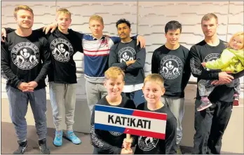  ??  ?? Katikati wrestlers, from left back row Josh Baron (coach), Sean Maguire, Ronin Ainsley, Suraj Singh, Eddie Beetham, Jason Harvey. Front: Hamish Tanner, Ben Tanner at the national championsh­ips in Dunedin.