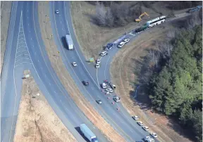  ??  ?? Aerial images of the scene of the bus accident outside Benton, Ark., that killed one boy from Orange Mound and injured 45 more. JOE RONDONE/THE COMMERCIAL APPEAL