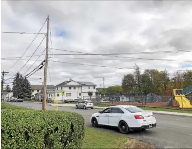  ?? NICHOLAS BUONANNO -- NBUONANNO@TROYRECORD.COM ?? A Cohoes police officer patrols the area near Van Schaick Island grade school on Continenta­l Avenue Monday morning.