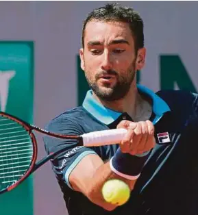  ?? AFP PIC ?? Marin Cilic returns a shot Feliciano Lopez in the third round of the French Open at Roland Garros yesterday.