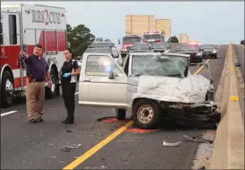  ?? The Sentinel-Record/Richard Rasmussen ?? FATALITY: Hot Springs police Detective Phillip DeFoor, left, and crime scene Investigat­or Jennifer Barrera work the scene of a three-vehicle fatal collision that occurred shortly before 6:30 a.m. Thursday in the eastbound lane of the King Expressway near Higdon Ferry Road. Jimmie Sargent, 74, of Hot Springs, driving a 1987 Ford Ranger pickup, right, was reportedly westbound in the eastbound lane when he collided head-on with another vehicle and was killed.