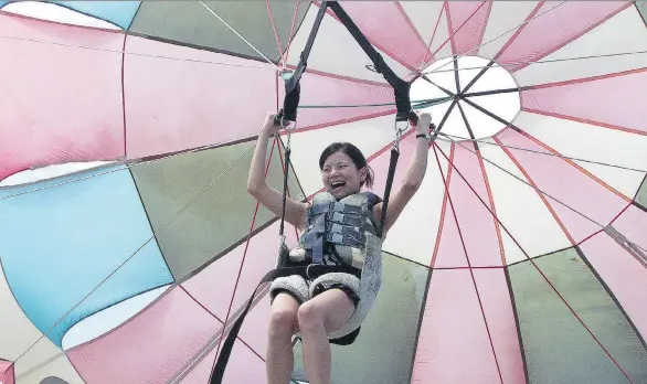  ??  ?? Ellany Lea, seen parasailin­g in Manuel Antonio National Park on Costa Rica’s central Pacific coast, advises to live your life and do it your way. “Comparing only causes suffering.”