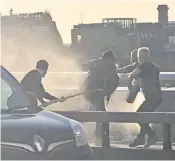  ??  ?? Usman Khan is tackled on London Bridge after killing two people and seriously injuring at least two more in Fishmonger­s’ Hall