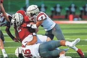  ?? ?? Nixa’s Spencer Ward, right, makes a tackle in the jamboree game between the Ozark Tigers and Kickapoo Chiefs on Friday at Ozark.