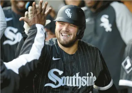  ?? CHRIS SWEDA/CHICAGO TRIBUNE ?? The White Sox’s Jake Burger is congratula­ted in the dugout after hitting a three-run home run against the Phillies at Guaranteed Rate Field in April.