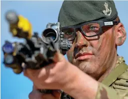  ?? ?? Bullseye: British soldier takes aim wearing special goggles