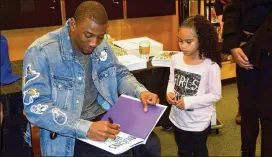  ?? ALEXIS STEVENS / ASTEVENS@AJC.COM ?? Malcolm Mitchell, a former UGA player who plays for the New England Patriots, signed his children’s book, “The Magician’s Hat,” Saturday in Atlanta.