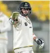  ??  ?? Michael Papps celebrates becoming the first century maker in a day-night first-class game in New Zealand.