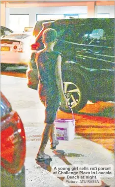  ?? Picture: ATU RASEA ?? A young girl sells roti parcel at Challenge Plaza in Laucala Beach at night.