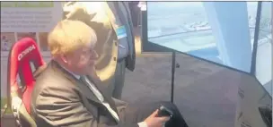  ??  ?? n IN CONTROL: MP Boris Johnson takes the helm of a helicopter simulator during a visit to the Children’s Air Ambulance