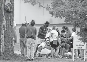  ?? EPA ?? A person is treated by emergency medical personnel after lightning struck a pine tree during a weather delay at the Tour Championsh­ip.
