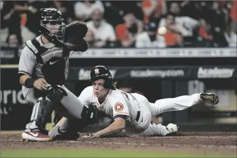  ?? DAVID J. PHILLIP/AP ?? HOUSTON ASTROS’ JAKE MEYERS (RIGHT) scores as Arizona Diamondbac­ks catcher Daulton Varsho reaches for the ball during the 10th inning of a game Saturday in Houston.