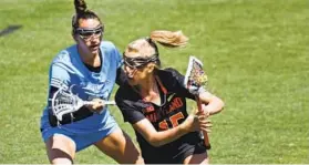  ?? KIM HAIRSTON/BALTIMORE SUN ?? Johns Hopkins’ Jeanne Kachris defends Maryland’s Aurora Cordingley, a former Blue Jays star, during Friday’s game at Homewood Field. Kachris scooped up two ground balls and blanketed her former roommate in seven-on-seven situations.