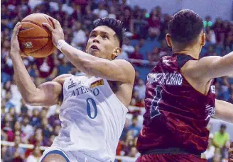  ??  ?? Thirdy Ravena of Ateneo drives strong to the hoop against Javi Gomez de Liaño of UP yesterday at the Big Dome.