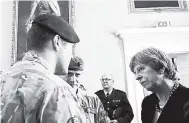  ?? AP ?? Britain’s Prime Minister Theresa May speaks to members of military as she visits Salisbury southwest England yesterday.