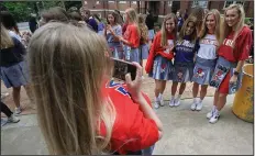  ?? (Arkansas Democrat-Gazette/Staton Breidentha­l) ?? In this 2018 file photo, Mount St. Mary Academy senior Abby Chandler (far left) takes a picture of classmates (left to right) Mandy Jeffery, Griffyn Gentry, Caroline Johnson and Lauren Williams during a pizza party at the school, where students decorated their uniform skirts and wore T-shirts from the colleges they were set to attend in the fall. Students returning to Catholic schools in Arkansas this month will see changes including Arkansas Department of Health directives such as masks and social distancing during the coronaviru­s pandemic.