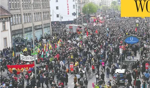  ?? TOBIAS SCHWARZ / AFP VIA GETTY IMAGES ?? Thousands march on Saturday in a Labour Day protest in Berlin. Ninety-three police officers were injured.