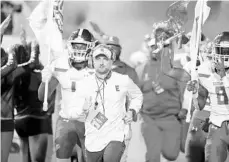  ?? STEPHEN M. DOWELL/ORLANDO SENTINEL ?? Edgewater High football coach Cameron Duke leads his team onto the field for its 2019 Class 7A state championsh­ip game against St. Thomas Aquinas of Fort Lauderdale at Daytona Stadium. The Eagles lost 28-23. Edgewater’s 2020 schedule is in flux due to the coronaviru­s pandemic.