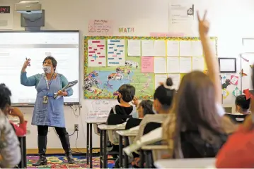  ?? PHOTOS BY LUIS SÁNCHEZ SATURNO/THE NEW MEXICAN ?? Xhevahire Krasniqi teaches a combined grade level class last month at Sweeney Elementary School. Due to a drop in enrollment, almost all classes are combined classes at Sweeney. Enrollment dropped from 361 last year to 309 this year. With such a dramatic decline in students, is it time for the district to consider closing campuses?