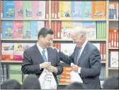  ?? DAMIAN DOVARGANES — THE ASSOCIATED PRESS FILE ?? Chinese Vice President Xi Jinping and Vice President Joe Biden hold T-shirts students gave them at the Internatio­nal Studies Learning Center in South Gate.