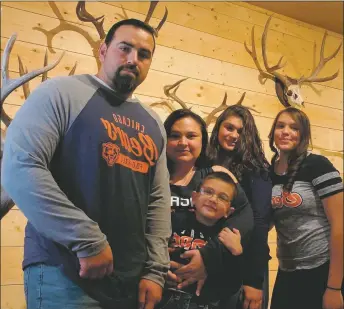  ?? COURTESY OF MONICA HERRERA ?? (From left) Marcos, Monica, Marcdavid, Isabel, and Vanessa Herrera pose for a family photo in their shop, Taos Hunting Co.