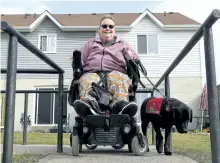  ?? CLIFFORD SKARSTEDT/EXAMINER ?? Elaine Hewitt and her service dog Gracie outside their home Tuesday. Hewitt and her service dog use Handi Van services often, and she says it's getting more and more difficult to reserve a ride - so much so that she's considerin­g buying her own...
