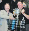  ??  ?? Vancouver Giants owner Ron Toigo, left, accepts the Memorial Cup from Ed Chynoweth, the longtime WHL and CHL president, in 2005.