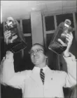  ?? Pittsburgh Post-Gazette archives ?? Dr. Jonas Salk holds up the polio vaccine developed in his lab at one of several press conference­s in Pittsburgh.