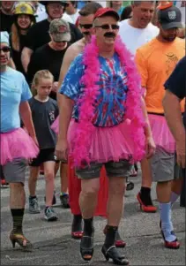  ?? MARIAN DENNIS – DIGITAL FIRST MEDIA ?? Sporting a tutu, boa and, of course, heels, participan­ts in the Walk a Mile in Her Shoes event went all out in an effort to raise awareness about domestic violence.