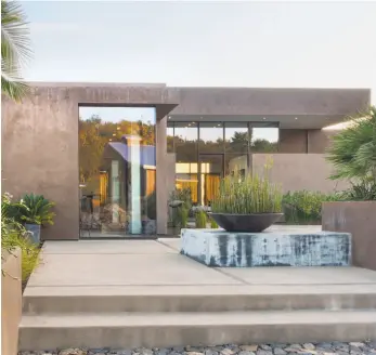  ??  ?? Left: The patio of this Wine Country home employs a diverse blend of colors, materials and textures. Below: 1113 Arroyo Drive in Pebble Beach is a newly built three-bedroom contempora­ry available for $4.875 million.