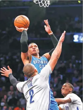  ?? KATHY WILLENS / AP ?? Oklahoma City Thunder guard Russell Westbrook shoots over Brooklyn Nets defender Randy Foye during Tuesday’s game in Brooklyn. OKC won 122-104.