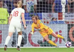  ??  ?? United States goalkeeper Alyssa Naeher dives to make a save on a penalty kick in Stade de Lyon in Decines-Charpieu, France, on Tuesday.