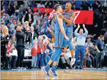  ??  ?? Oklahoma City's Danilo Gallinari (8) celebrates with Chris Paul (3) after making a 3-pointer in overtime of a 127-119 against Philadelph­ia on Friday at Chesapeake Arena. [BRYAN TERRY/ THE OKLAHOMAN]