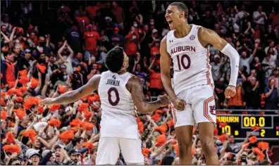  ?? (AP/Butch Dill) ?? Guard K.D. Johnson (left) and forward Jabari Smith (10) celebrate Wednesday after No. 11 Auburn defeated No. 16 LSU 70-55 in Auburn, Ala.