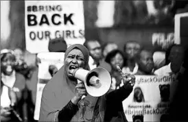  ?? AFOLABI SOTUNDE/REUTERS ?? A protester addresses a demonstrat­ion in May in Abuja, Nigeria’s capital, aimed at gaining freedom for the schoolgirl­s who were abducted by militants from Boko Haram.