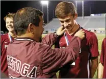  ?? KIRCK NEIDERMYER — FOR DIGITAL FIRST MEDIA ?? Conestoga head coach David Zimmerman presents Chris Donovan with his medal after winning the PIAA Class 4A championsh­ip at Hersheypar­k Stadium on Friday, November 17.