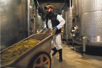  ?? Santiago Mejia / The Chronicle 2015 ?? Luke Neu carts hops at the venerable Anchor Brewing plant on Potrero Hill in April 2015. The company was founded in the 1870s, using the steam-beer process dating to the Gold Rush.