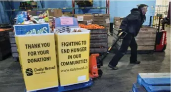  ?? ANDREW FRANCIS WALLACE./TORONTO STAR ?? Paul Huckvale moves a skid at a food bank. The city releases a sweeping new anti-poverty plan Tuesday.