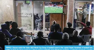  ?? ?? TRIPOLI: Libyans watch the Qatar 2022 World Cup Group A football match in the capital Tripoli. Hundreds of football fans gather in front of a huge screen in a Libyan park to watch the day’s World Cup matches, a welcome escape in a country wracked by conflict. —AFP