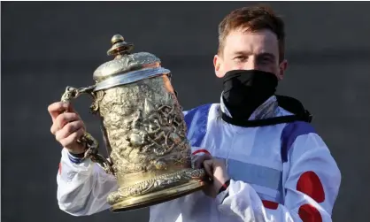  ??  ?? Sam Twiston-Davies celebrates winning the Punchestow­n Gold Cup on Clan Des Obeaux on only his third visit to the track in the past 12 years. Photograph: Brian Lawless/PA